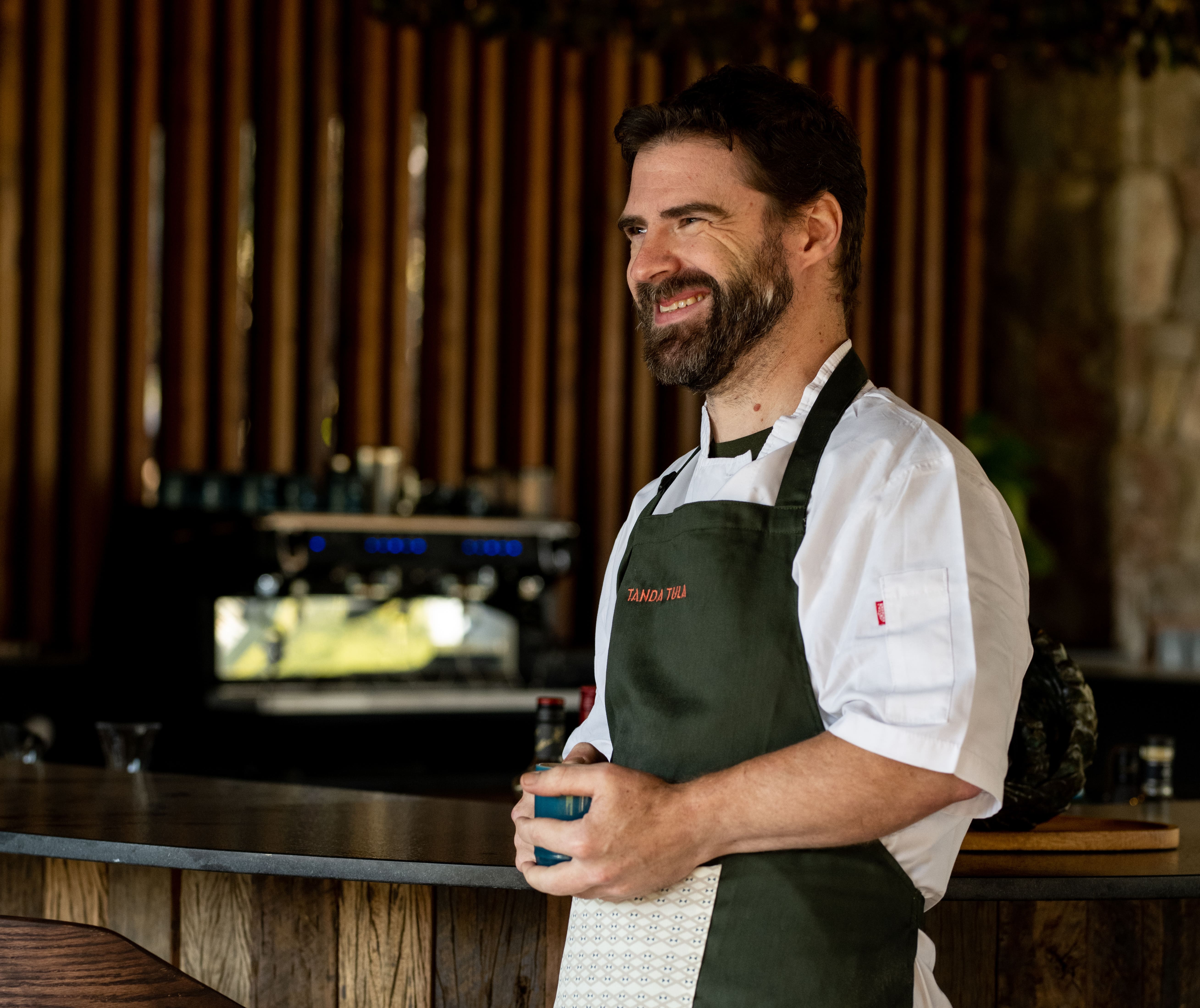 Chef and kitchen team preparing fresh meals in the open-air bush kitchen
