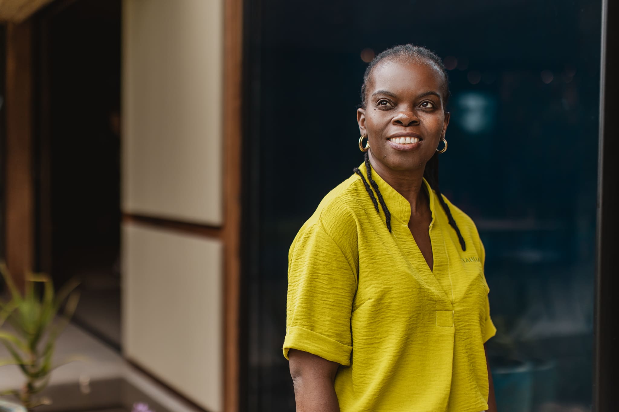 Tanda Tula team member smiling warmly while standing at the safari camp in the Timbavati.