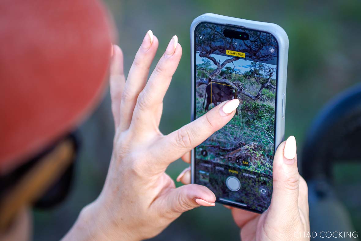 iPhone camera screen showing the user touching and holding on the subject to lock exposure.