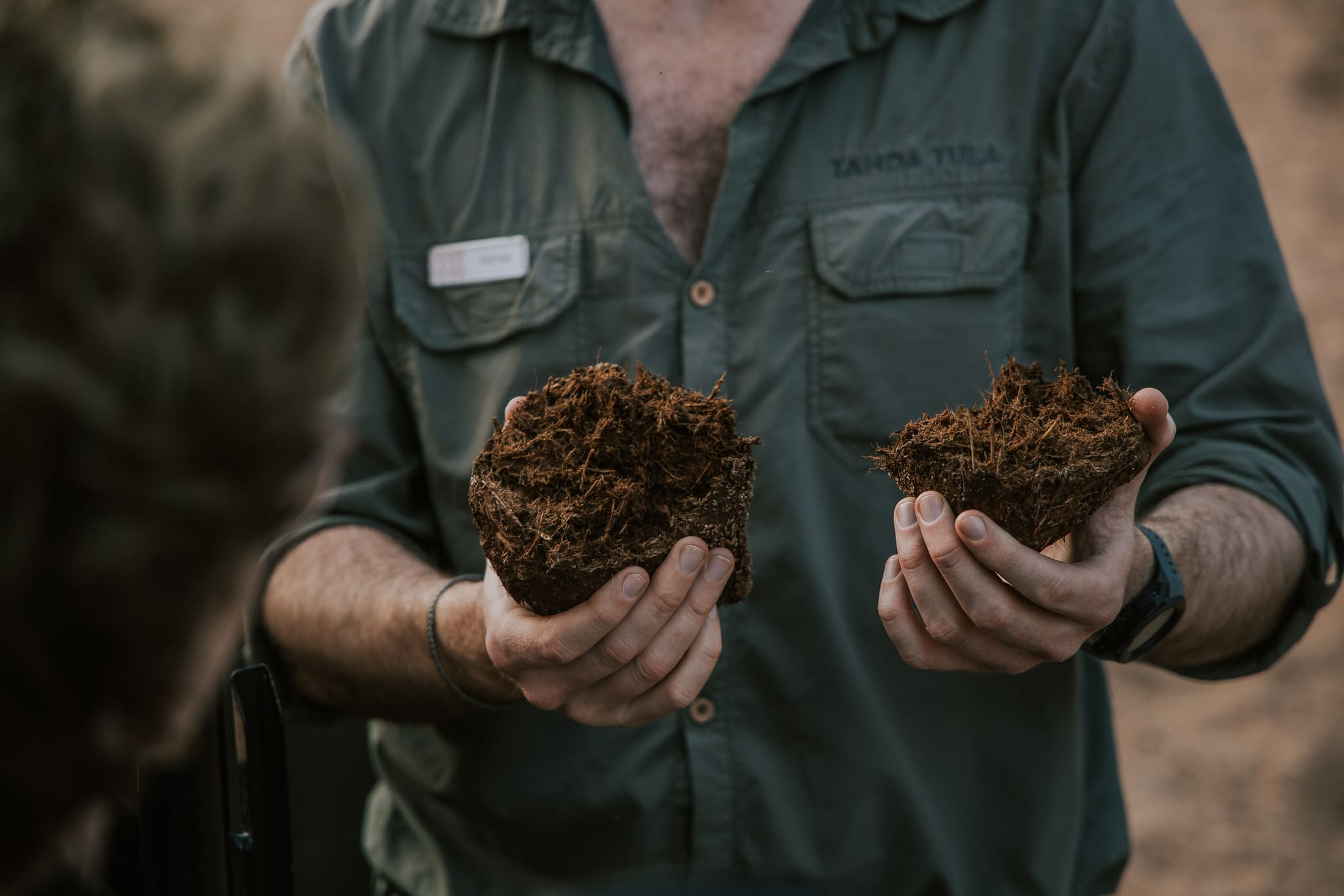Field guide Tristan Allan-Reynolds holding soil samples while explaining the landscape at Tanda Tula.