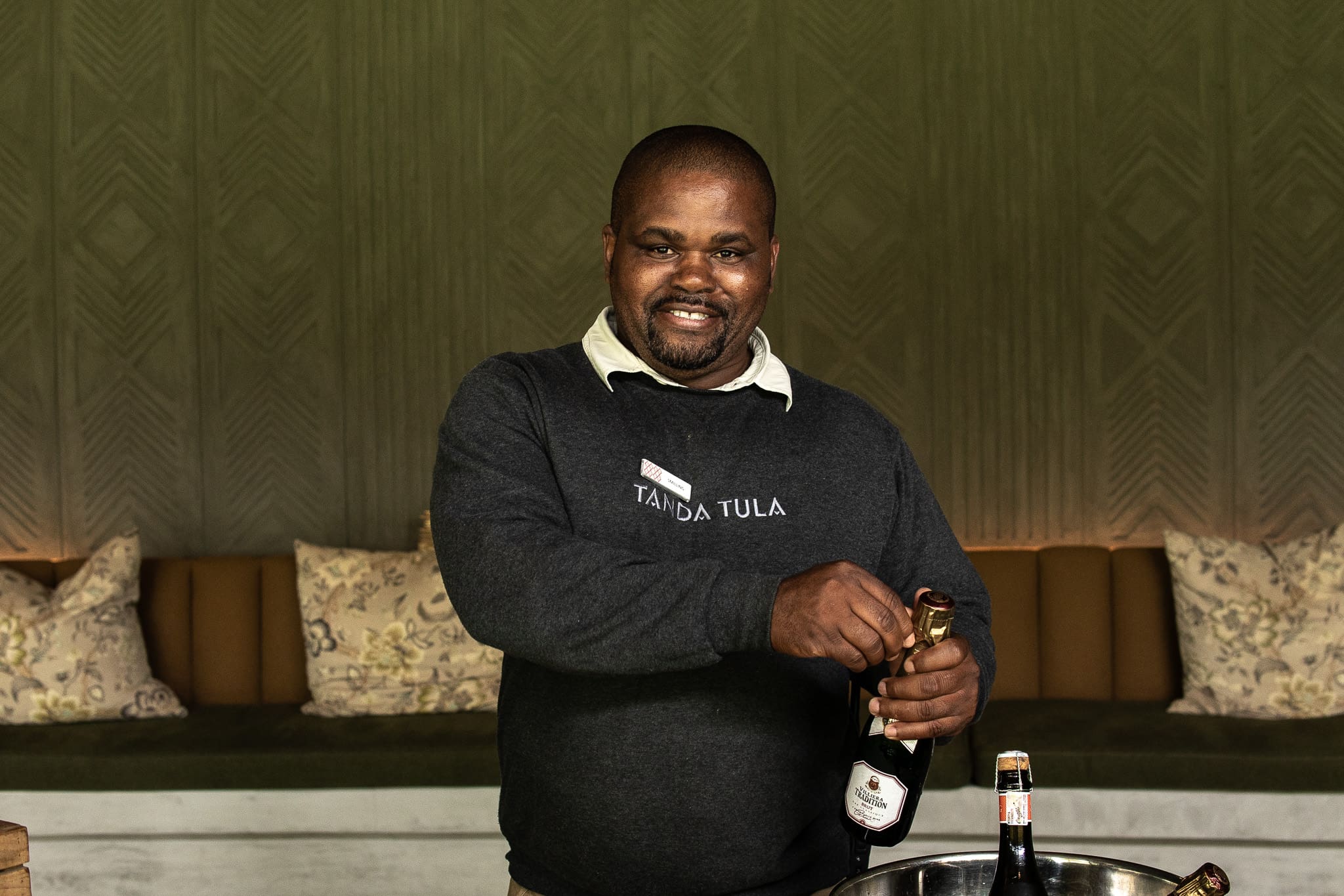 Smiling preparing an Aperol Spritz at Tanda Tula Safari Camp during a summer afternoon