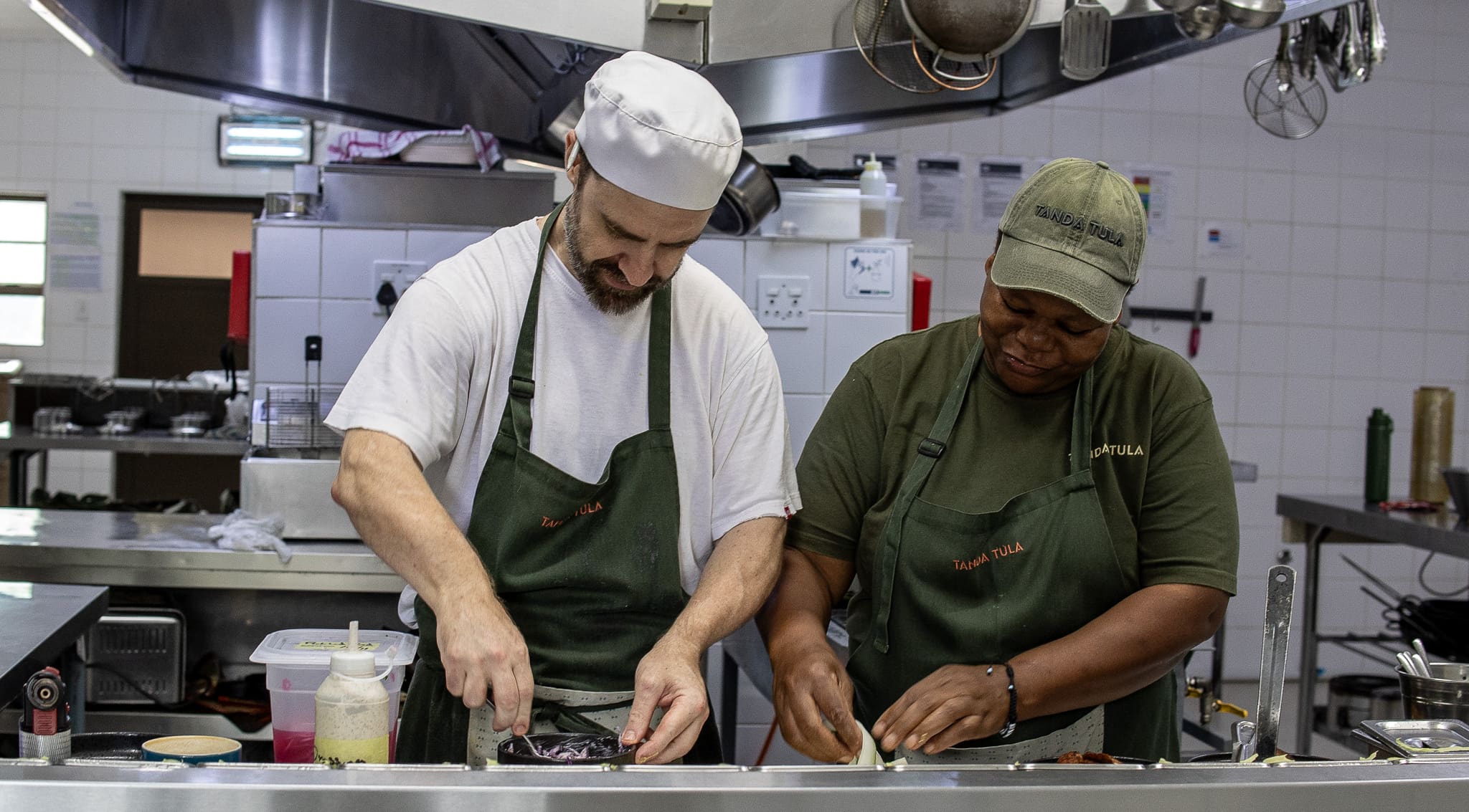 Chef Ryan preparing dishes alongside the kitchen team at Tanda Tula Safari Camp