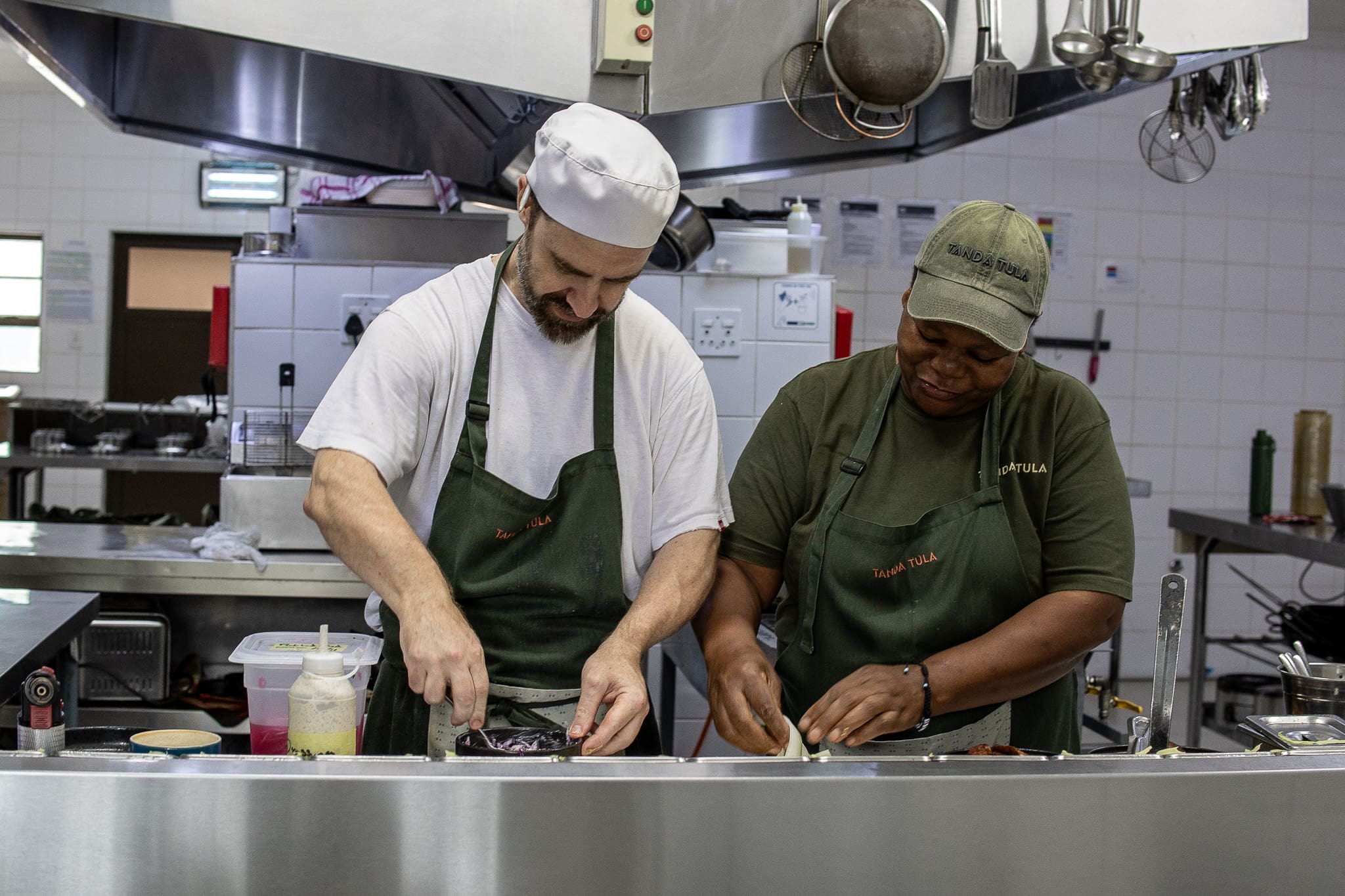 Chef Ryan preparing dishes alongside the kitchen team at Tanda Tula Safari Camp